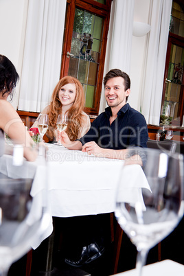 smiling happy people in restaurant