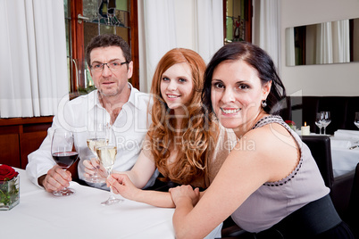 smiling happy people in restaurant