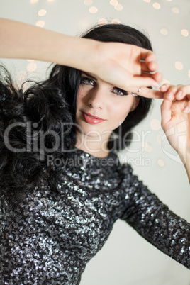 Beautiful dreamy woman with glitter dress dancing