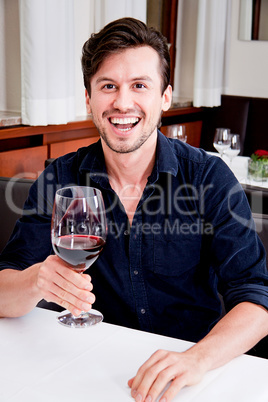 couple drinking red wine in restaurant