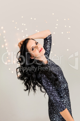 Beautiful dreamy woman with glitter dress dancing