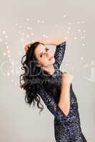 Beautiful dreamy woman with glitter dress dancing