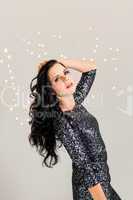 Beautiful dreamy woman with glitter dress dancing