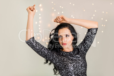 Beautiful dreamy woman with glitter dress dancing