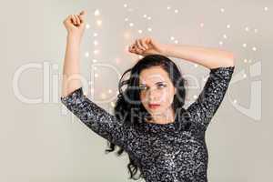 Beautiful dreamy woman with glitter dress dancing