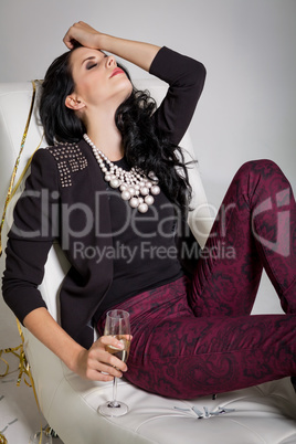 Seductive brunette holding a glass of champagne