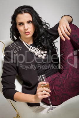 Seductive brunette holding a glass of champagne