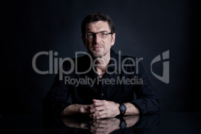 attractive adult man with glasses on black background