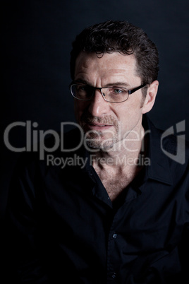 attractive adult man with glasses on black background