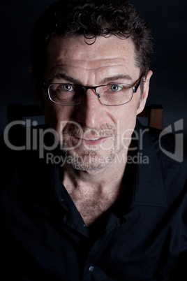 attractive adult man with glasses on black background