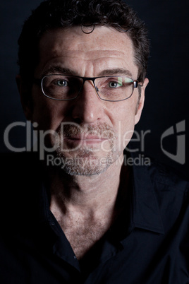 attractive adult man with glasses on black background