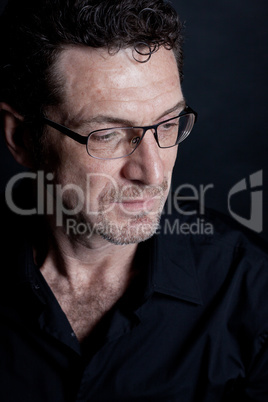 attractive adult man with glasses on black background