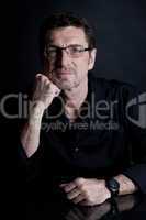 attractive adult man with glasses on black background