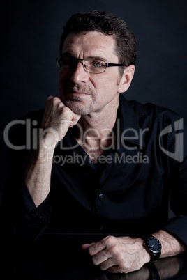 attractive adult man with glasses on black background