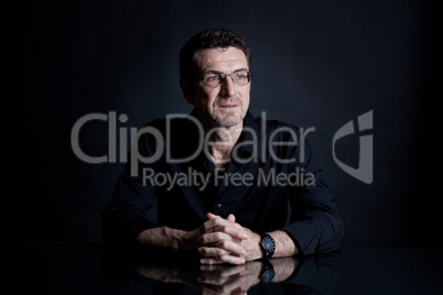 attractive adult man with glasses on black background