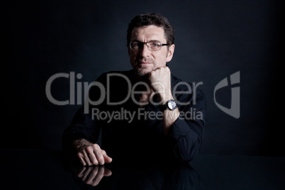 attractive adult man with glasses on black background