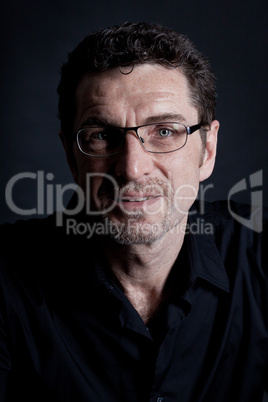 attractive adult man with glasses on black background