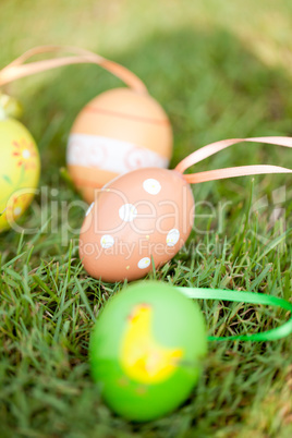 colored easter eggs group in green grass outdoor in spring