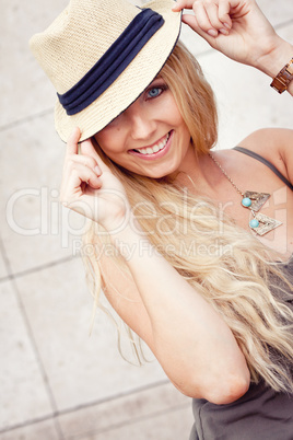 happy young blonde woman with hat outdoor summertime