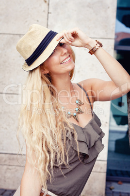 happy young blonde woman with hat outdoor summertime