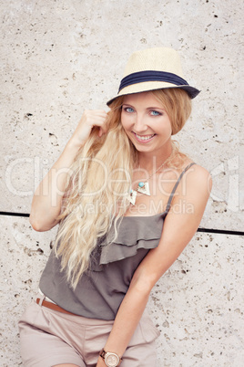 happy young blonde woman with hat outdoor summertime