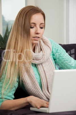 smiling woman on couch with notebook