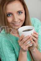 smiling young woman drinking coffee