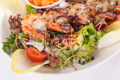 Grilled prawns with endive salad and jacket potato