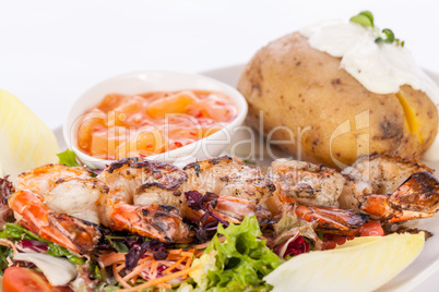 Grilled prawns with endive salad and jacket potato