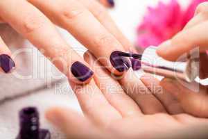 Woman having a nail manicure in a beauty salon