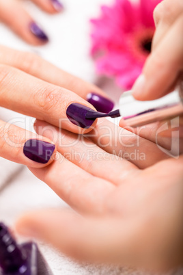 Woman having a nail manicure in a beauty salon