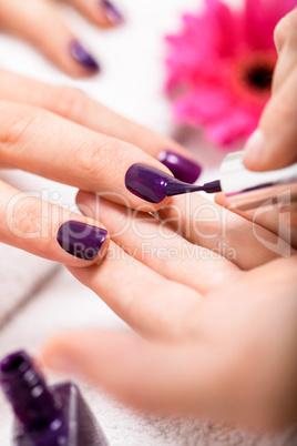 Woman having a nail manicure in a beauty salon