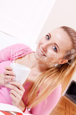 smiling young woman drinking coffee