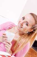 smiling young woman drinking coffee