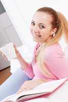 smiling young blonde woman drinking coffee