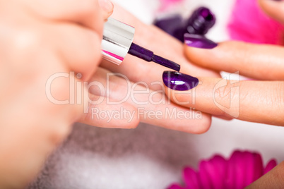 Woman having a nail manicure in a beauty salon