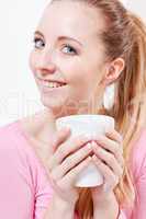 smiling young blonde woman drinking coffee