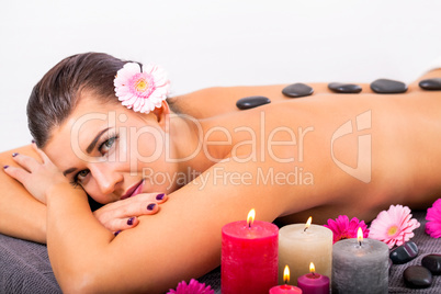 young attractive woman hot stone massage wellness