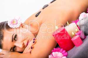 young attractive woman hot stone massage wellness