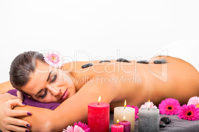 young attractive woman hot stone massage wellness