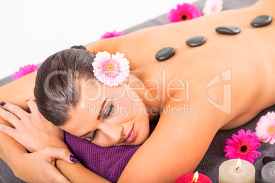 young attractive woman hot stone massage wellness