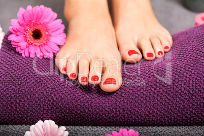 Bare feet of a woman surrounded by flowers