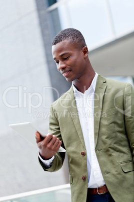 smiling successful businessman with tablet pc outdoor