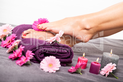 Bare feet of a woman surrounded by flowers