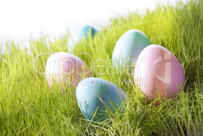 Many Decorative Easter Eggs On Sunny Green Grass