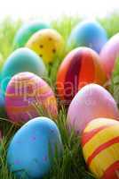 Many Colorful Easter Eggs On Sunny Green Grass