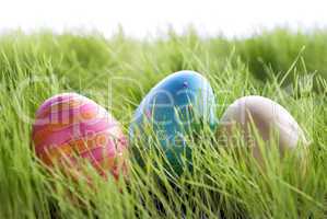 Three Colorful Easter Eggs On Green Gras