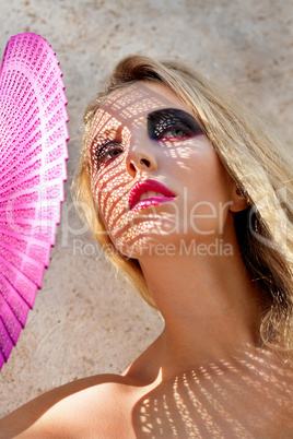 young beautiful woman with smokey eyes and pink lips