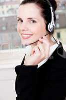 smiling young female callcenter agent with headset