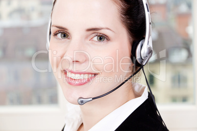 smiling young female callcenter agent with headset